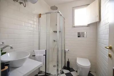 a bathroom with a shower and a sink and a toilet at iFlat Casa Viscuttara in Palermo