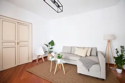 a white living room with a couch and a table at iFlat Casa Viscuttara in Palermo