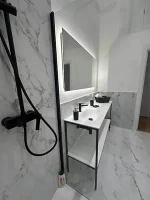 a white bathroom with a sink and a mirror at Lily Suite in Palermo