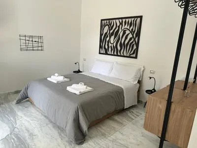 a bedroom with a bed with two towels on it at Lily Suite in Palermo