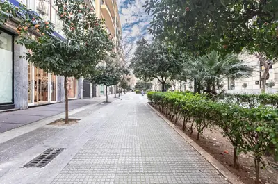 an empty city street with trees and bushes at GuestHost - Teatro Massimo Modern Studio in Palermo