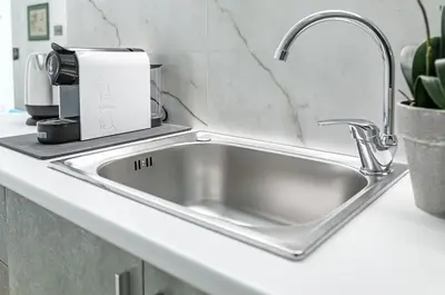 a stainless steel kitchen sink with a coffee maker at GuestHost - Teatro Massimo Modern Studio in Palermo