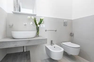 a white bathroom with a sink and a toilet at GuestHost - Teatro Massimo Modern Studio in Palermo