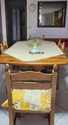 a wooden table with a chair with a table top at Milicia Apartment in Mandra Capreria
