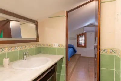 a bathroom with a sink and a mirror at Villa Seaside in Campofelice di Roccella