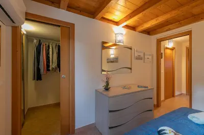 a bedroom with a bed and a vanity and a mirror at Villa Seaside in Campofelice di Roccella