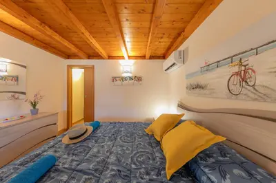 a bedroom with a bed with a hat on it at Villa Seaside in Campofelice di Roccella