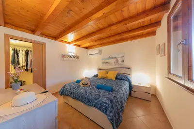 a bedroom with a bed and a sink in a room at Villa Seaside in Campofelice di Roccella