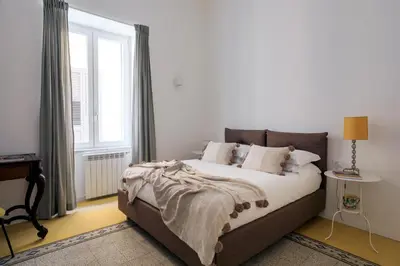 a bedroom with a bed and a large window at Ermosa Suite in Palermo