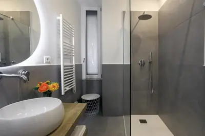 a bathroom with a white sink and a shower at Ermosa Suite in Palermo