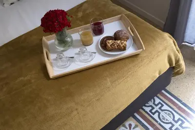 a tray with breakfast foods on a table at Ermosa Suite in Palermo