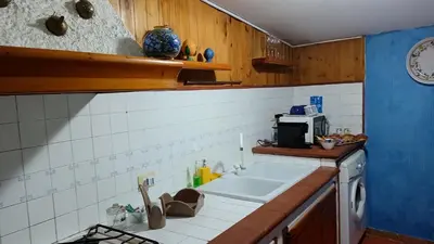 a kitchen with a sink and a microwave at LA TERRAZZA SUL MARE monolocale con terrazza vicino aereoporto&mare SICILIAN VINTAGE STYLE BEACH HOUSE in Cinisi