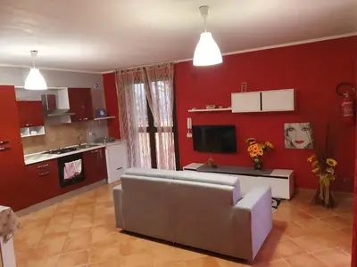 a living room with a couch and a kitchen at Holiday Home Villa Relax in Palermo