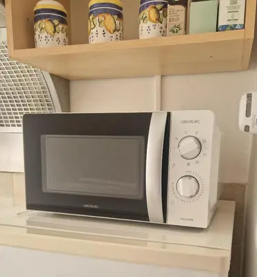 a microwave sitting on a counter next to a microwave oven at Politeama Holiday Home - La tua casa nel cuore di Palermo! in Palermo