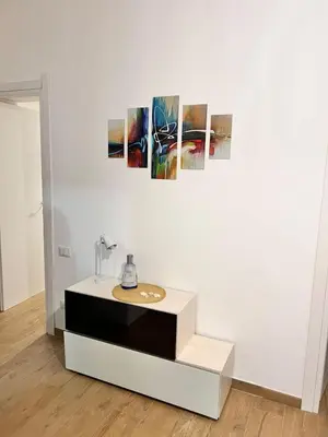 a white wall with three paintings on a wall at Casa Gabriele in Palermo