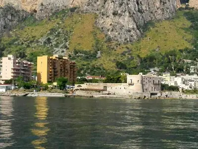 a city on the water next to a mountain at Casa Gabriele in Palermo