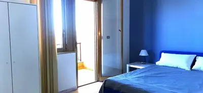 a blue bedroom with a bed and a mirror at Port Side Elegance Palermo in Palermo