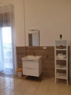 a bedroom with a bed and a window with a view at Port Side Elegance Palermo in Palermo