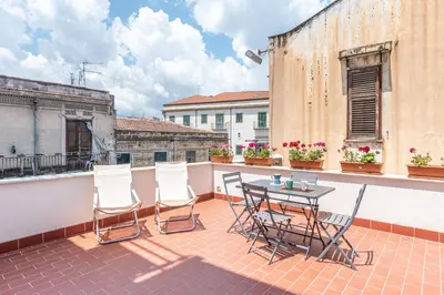 a patio with a table and chairs on a balcony at Casa Brunaccini con Terrazza by Wonderful Italy in Palermo