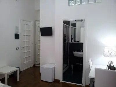a white bathroom with a mirror and a sink at B&B Paolo e Mariella in Palermo