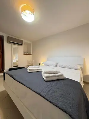 two beds in a room with towels on them at A Due Passi da Mondello in Palermo