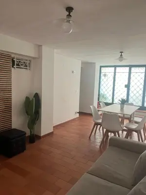 a living room with a table and chairs at A Due Passi da Mondello in Palermo