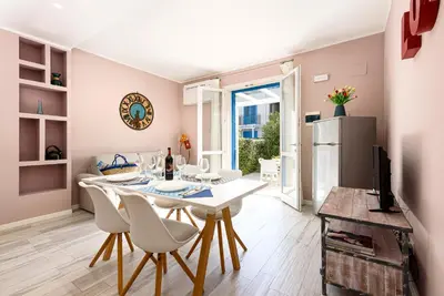 a kitchen and dining room with a table and chairs at I Tre Golfi - Residenza Cala Azzurra in San Vito lo Capo