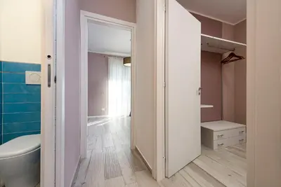 a bathroom with a white toilet and a sink at I Tre Golfi - Residenza Cala Azzurra in San Vito lo Capo