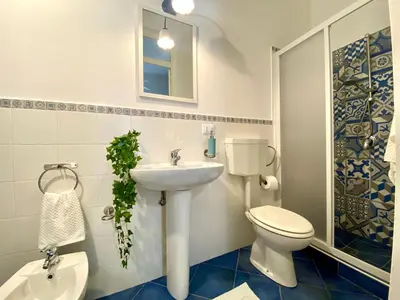 a bathroom with a toilet and a sink at Le Case di Anan, Castellammare del Golfo in Castellammare del Golfo