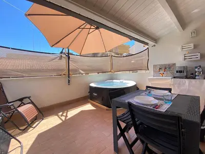 a patio with a table and an umbrella at Le Case di Anan, Castellammare del Golfo in Castellammare del Golfo