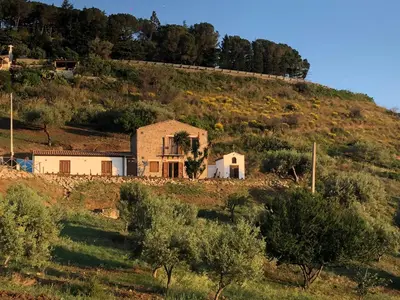 an old house on the side of a hill at Orto Raccolto in Termini Imerese