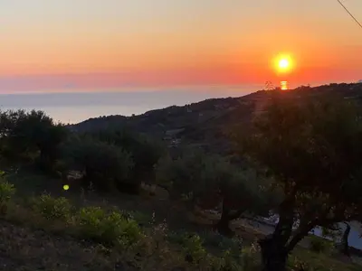 a sunset over a hill with trees and a river at Orto Raccolto in Termini Imerese