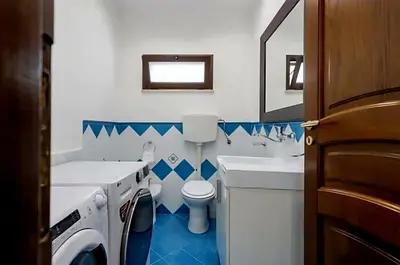 a bathroom with a sink and a toilet and a tub at Villa Antonio in Cinisi