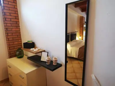 a mirror in a room with a bed and a bedroom at Kappa's house in Palermo