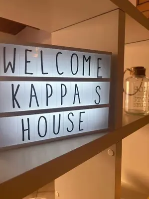 a sign for a welcome to kappas house on a shelf at Kappa's house in Palermo