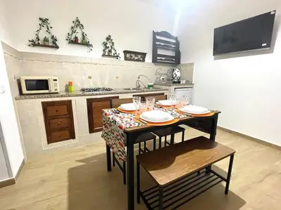a kitchen with a table with plates and glasses on it at Da Zia Maria in Palermo