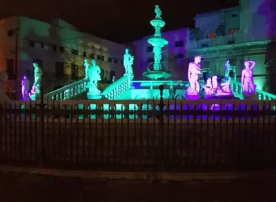 a building with a fountain with purple and green lights at Da Zia Maria in Palermo