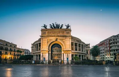 a large building with a statue in front of it at Shell Maqueda in Palermo
