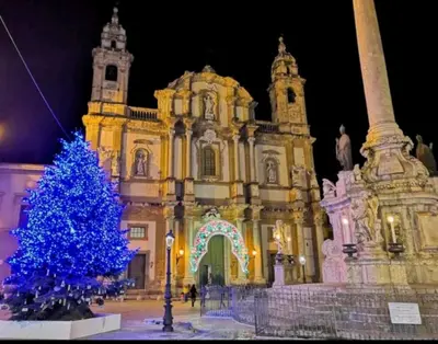 a blue christmas tree in front of a building at Shell Maqueda in Palermo