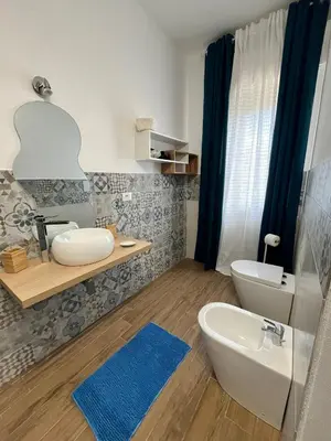 a bedroom with two twin beds and a lamp at La Chicca di Milu' for Pet Lovers in Alcamo