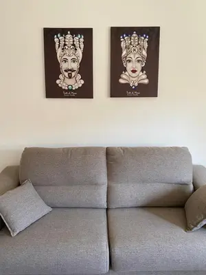 two posters on a wall above a couch at La Casa di Gus in Palermo