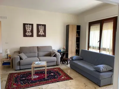 a living room with two couches and a table at La Casa di Gus in Palermo