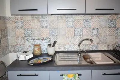 a kitchen counter with a sink and a plate on it at La Casa di Gus in Palermo