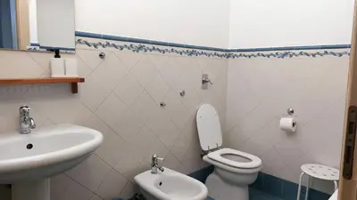 a bathroom with a toilet and a sink at Casa Santoliva in centro a Palermo in Palermo