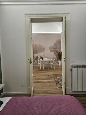 a bedroom with a door leading to a dining room at Sofia's Central Apartment Palermo in Palermo