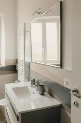 a bathroom with a white sink and a mirror at Sofia's Central Apartment Palermo in Palermo