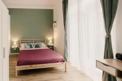 a bedroom with a bed and a large window at Sofia's Central Apartment Palermo in Palermo