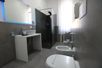 a bathroom with a sink and a toilet and a tub at Il Siciliano room’s & suite in Palermo