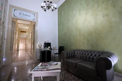 a living room with a couch and a table at Il Siciliano room’s & suite in Palermo