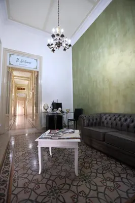 a living room with a couch and a table at Il Siciliano room’s & suite in Palermo